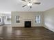Spacious living room featuring hard wood floors, a fireplace, and lots of natural light at 95 Cinnamon Teal Way, Youngsville, NC 27596