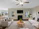 Bright living room with a fireplace and lots of windows at 95 Cinnamon Teal Way, Youngsville, NC 27596