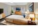 Comfortable main bedroom with a large bed, dresser, and windows that provide natural light at 95 Cinnamon Teal Way, Youngsville, NC 27596