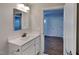 Bathroom featuring a single sink vanity and mirror with decorative lighting at 96 Saddleback Rd, Fuquay Varina, NC 27526