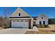 Inviting single-Gathering home featuring a 2-car garage, stone accents, and a bright blue front door at 96 Saddleback Rd, Fuquay Varina, NC 27526