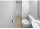 Bathroom with a white toilet, tile floor, and a combined shower-tub area at 1004 Carlisle St, Raleigh, NC 27610