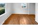 Hardwood flooring, large window, and ample natural light make this bedroom ideal for relaxation and rejuvenation at 1004 Carlisle St, Raleigh, NC 27610