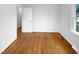 This room features hardwood flooring, a closet, and a window to the outside at 1004 Carlisle St, Raleigh, NC 27610