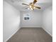 A carpeted room with a ceiling fan and one window providing ample natural light at 1004 Carlisle St, Raleigh, NC 27610