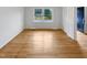 Bright bedroom with hardwood floors and a view to the front yard, providing a light and airy ambiance at 1004 Carlisle St, Raleigh, NC 27610