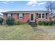 Charming brick home with well-maintained front yard and classic architectural details, offering a welcoming curb appeal at 1004 Carlisle St, Raleigh, NC 27610
