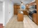 A kitchen with wood cabinets, stainless steel appliances, and granite countertops with tile flooring at 1004 Carlisle St, Raleigh, NC 27610