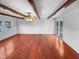 Living room featuring hardwood flooring, exposed ceiling beams, and sliding glass doors at 1004 Carlisle St, Raleigh, NC 27610