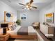 A stylish main bedroom with a ceiling fan, neutral decor, and carpet, creating a calming personal space at 1004 Carlisle St, Raleigh, NC 27610