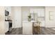Contemporary kitchen with a central island, stainless steel appliances, and stylish bar stools at 1006 Sora Way, Durham, NC 27703