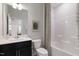 Bathroom with single sink, dark cabinets and shower with patterned shower curtain at 1010 Sora Way, Durham, NC 27703