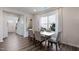 Bright dining room featuring wood-look floors, a large window, and modern decor at 1010 Sora Way, Durham, NC 27703