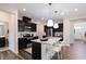 Spacious kitchen with dark wood cabinets, stainless steel appliances, and granite counters at 1010 Sora Way, Durham, NC 27703