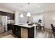 Kitchen with stainless appliances, dark wood cabinets, and a bright open layout at 1010 Sora Way, Durham, NC 27703