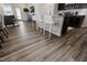 Open-concept kitchen with island and seating area with luxury vinyl plank flooring and view to the patio at 1010 Sora Way, Durham, NC 27703