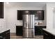 Modern kitchen with stainless steel refrigerator and dark wood cabinets at 1010 Sora Way, Durham, NC 27703