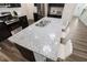 Kitchen island featuring granite countertops and a stainless steel sink with seating on wood grain floors at 1010 Sora Way, Durham, NC 27703