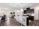 Modern kitchen with a large island, stainless steel appliances, and a breakfast bar at 1010 Sora Way, Durham, NC 27703
