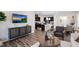 Spacious living area showcasing luxury vinyl plank flooring, modern kitchen, and comfortable seating at 1010 Sora Way, Durham, NC 27703