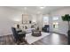 Bright living room with modern decor, featuring a white sofa, area rug, and luxury vinyl plank flooring at 1010 Sora Way, Durham, NC 27703