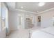Bright main bedroom featuring trey ceiling, neutral decor, and ensuite bathroom and walk-in closet at 1010 Sora Way, Durham, NC 27703