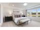 Serene main bedroom with neutral tones, carpet, tray ceiling, and large windows offering ample natural light at 1010 Sora Way, Durham, NC 27703