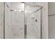 Modern shower featuring sleek glass doors, tiled walls, and elegant fixtures at 1018 Salt Glaze Ln, Cary, NC 27519
