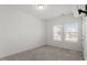 A bright bedroom offers two windows and neutral carpet at 1018 Salt Glaze Ln, Cary, NC 27519