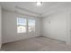 Bright bedroom featuring plush carpeting, tray ceiling, and double windows for natural light at 1018 Salt Glaze Ln, Cary, NC 27519
