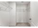 Walk-in closet featuring ample storage with metal shelving and neutral carpeting at 1018 Salt Glaze Ln, Cary, NC 27519