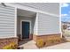Attractive townhome entrance with brick accents and well-manicured landscaping at 1018 Salt Glaze Ln, Cary, NC 27519