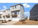 Stylish two-story townhome featuring a garage and a balcony overlooking a landscaped yard at 1018 Salt Glaze Ln, Cary, NC 27519