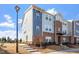 Beautiful townhome showcases brick and blue siding, complemented by landscaped grounds at 1018 Salt Glaze Ln, Cary, NC 27519