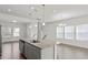 Modern kitchen island with granite countertops, stainless steel appliances, and sleek pendant lighting at 1018 Salt Glaze Ln, Cary, NC 27519