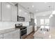 Modern kitchen features granite countertops, gray cabinets, and stainless steel appliances at 1018 Salt Glaze Ln, Cary, NC 27519