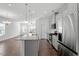 Stylish open kitchen with stainless steel appliances and granite countertops, perfect for cooking at 1018 Salt Glaze Ln, Cary, NC 27519
