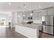 Modern kitchen features granite counters, gray cabinets, and stainless steel appliances at 1018 Salt Glaze Ln, Cary, NC 27519