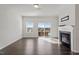 Bright living room boasts hardwood floors, a modern fireplace, and natural light from windows at 1018 Salt Glaze Ln, Cary, NC 27519