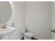 Cozy powder room with pedestal sink, sleek fixtures, and a modern toilet at 1018 Salt Glaze Ln, Cary, NC 27519