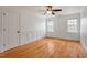 Spacious bedroom with hardwood floors, crown molding, and natural light from multiple windows at 109 Coffeeberry Ct, Garner, NC 27529