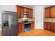 This kitchen features stainless steel appliances, wooden cabinets and hardwood floors at 109 Coffeeberry Ct, Garner, NC 27529