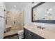 Well-lit bathroom featuring a walk-in shower and a modern vanity at 113 Witheridge Ct, Apex, NC 27502