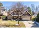 Charming brick and siding home featuring an attached two-car garage and a well-manicured lawn at 113 Witheridge Ct, Apex, NC 27502