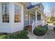 Home exterior showcasing a brick foundation, well-manicured landscaping, and inviting front porch at 1137 Chilmark Ave, Wake Forest, NC 27587