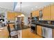 Modern kitchen with stainless steel appliances, a black backsplash, and wood cabinets at 1137 Chilmark Ave, Wake Forest, NC 27587