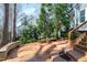 Paver patio in back of home featuring mature trees and landscaping at 115 Ripplewater Ln, Cary, NC 27518