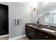 Bathroom featuring a double vanity with granite countertop, decorative mirrors, and modern lighting at 115 Ripplewater Ln, Cary, NC 27518