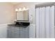 Traditional bathroom featuring a vanity with dark granite countertop and a white shower curtain at 115 Ripplewater Ln, Cary, NC 27518