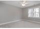 Bright empty bedroom featuring neutral colored carpet and walls with one large window at 115 Ripplewater Ln, Cary, NC 27518